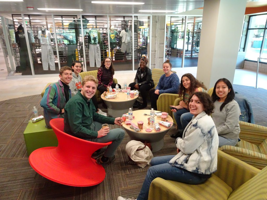 Group of 9 K College students having a picnic indoors at the First French Day in Detroit.